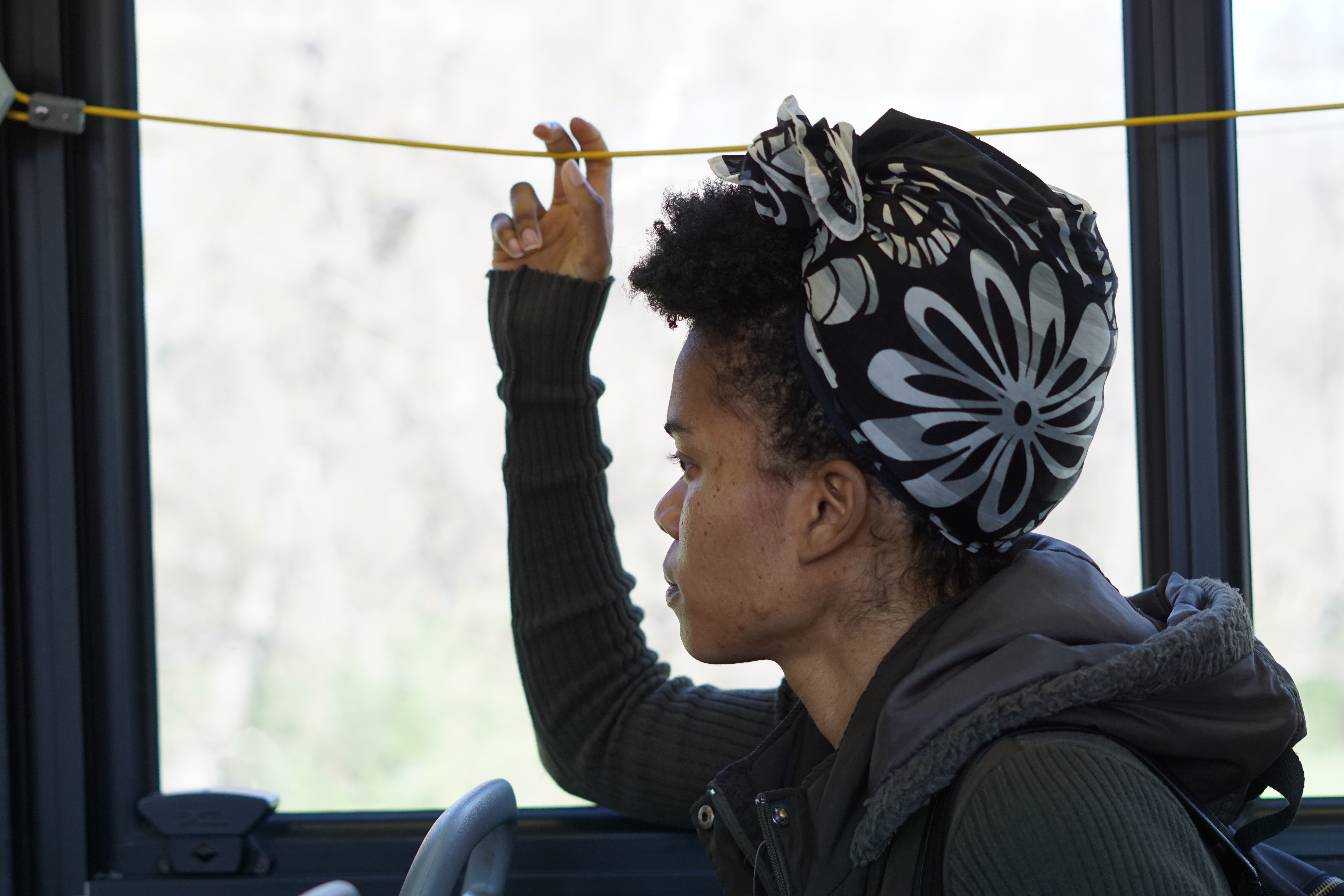 Photo of rider pulling the cord on bus